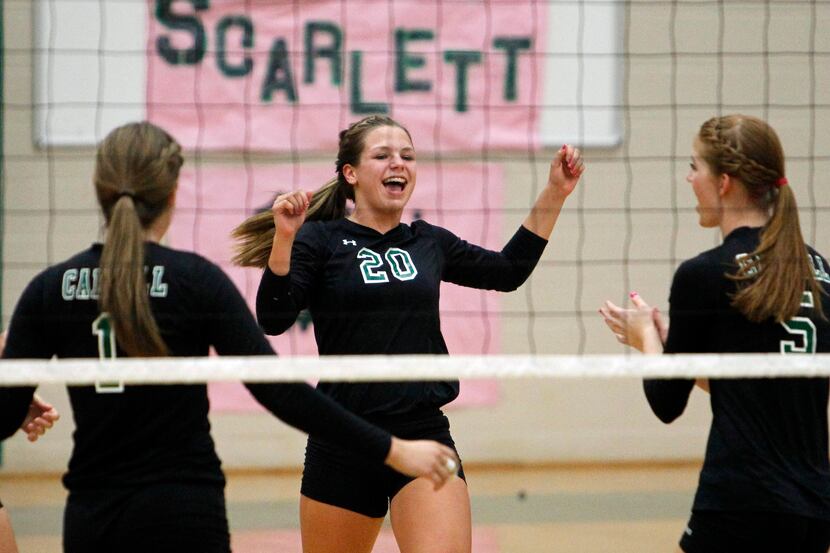 Carroll's Cat McCoy (20)celebrates with teammates after a point during the girls high school...
