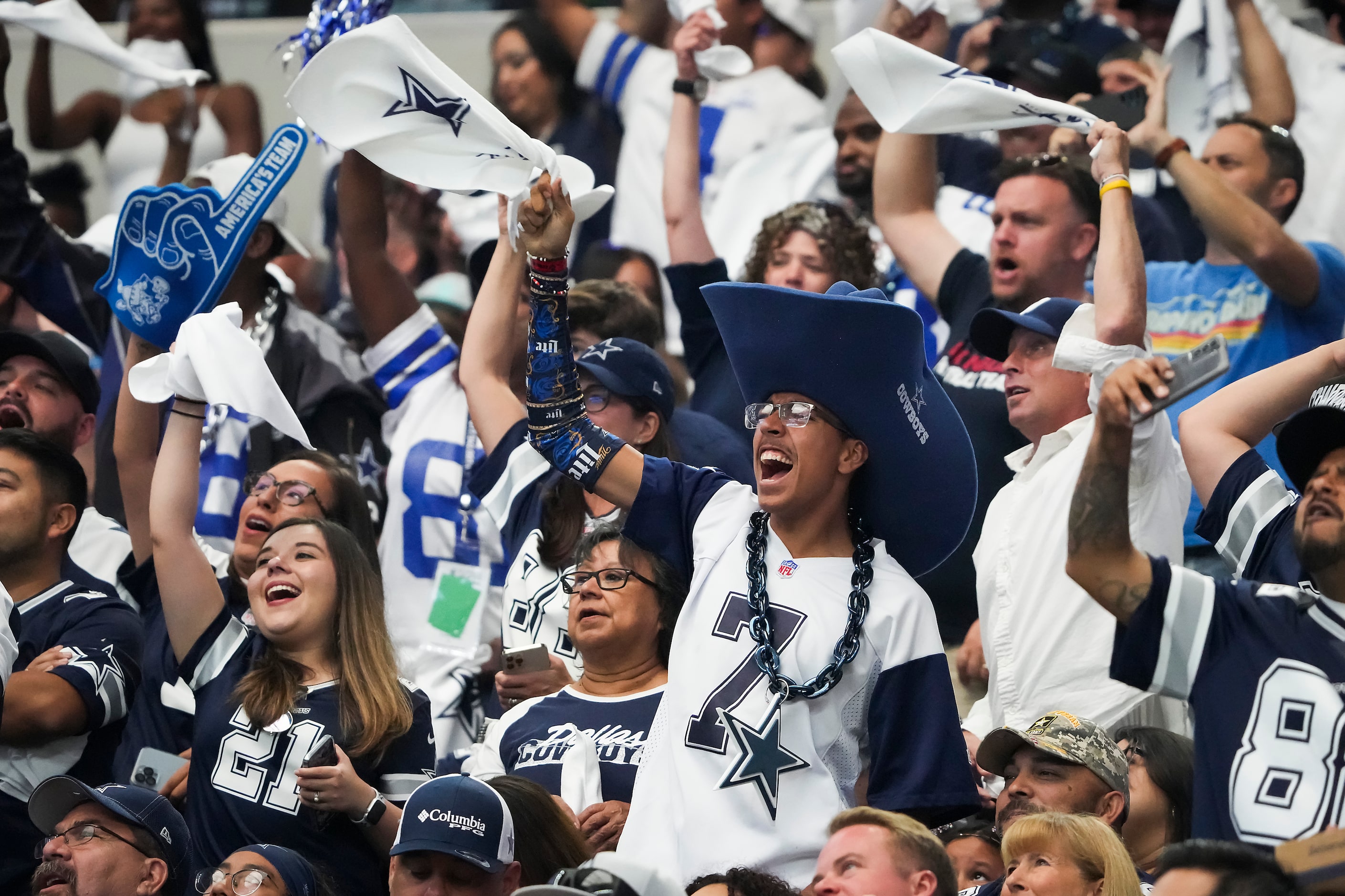 Dallas Cowboys fans cheer their defense during the first half of an NFL football game...