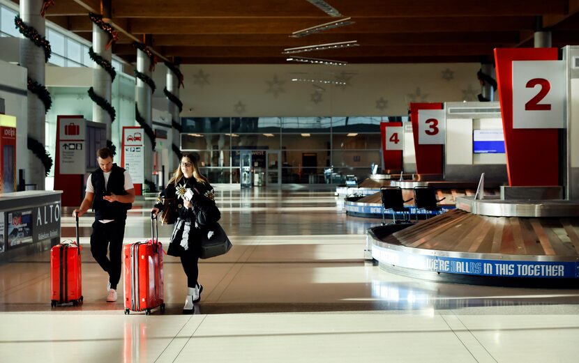 Southwest Airlines passengers retrieve their baggage as they arrive at Love Field in Dallas...