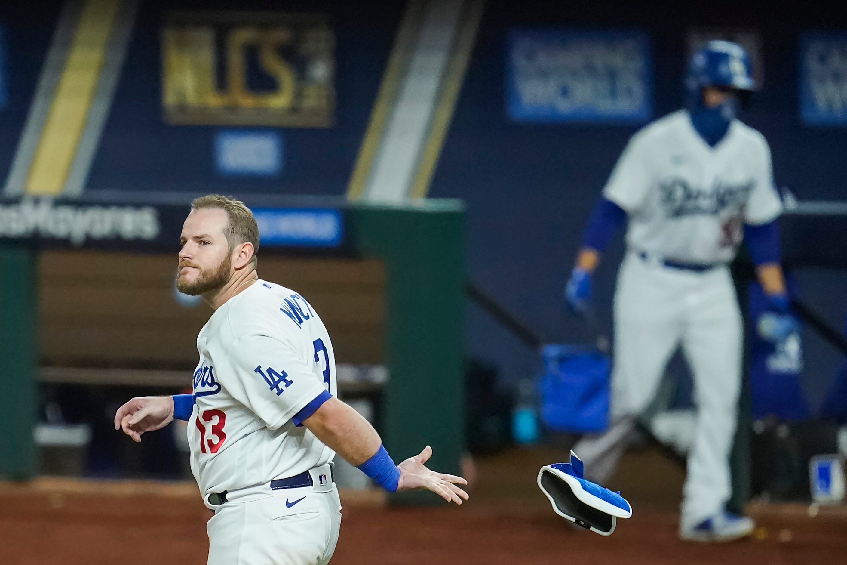 Los Angeles Dodgers first baseman Max Muncy reacts after striking out against Atlanta Braves...