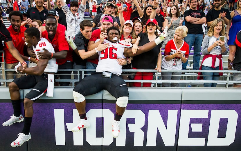 Texas Tech defensive lineman Broderick Washington (96) and wide receiver Michael Coley (80)...