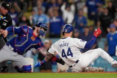 Texas Rangers catcher Jonah Heim, left, tags out Los Angeles Dodgers' Andy Pages sliding...