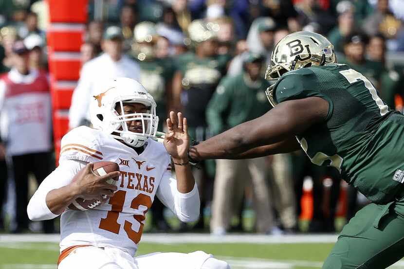 Texas quarterback Jerrod Heard (13) is hit by Baylor defensive tackle Andrew Billings during...
