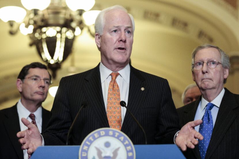 Sen. John Cornyn, R-Texas, with Senate minority leader Mitch McConnell of Kentucky (right)...