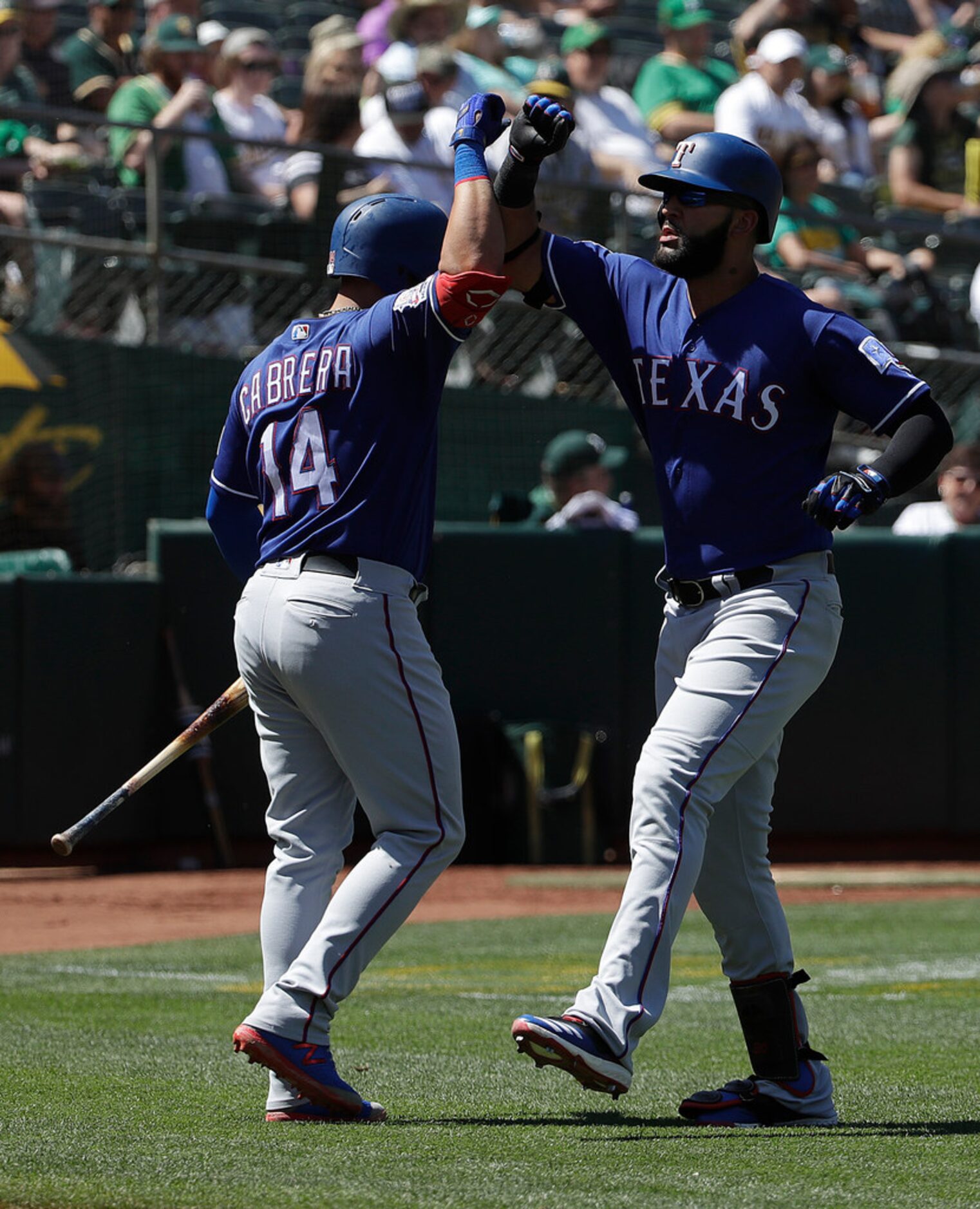 Texas Rangers' Nomar Mazara, right, celebrates with Asdrubal Cabrera after hitting a solo...