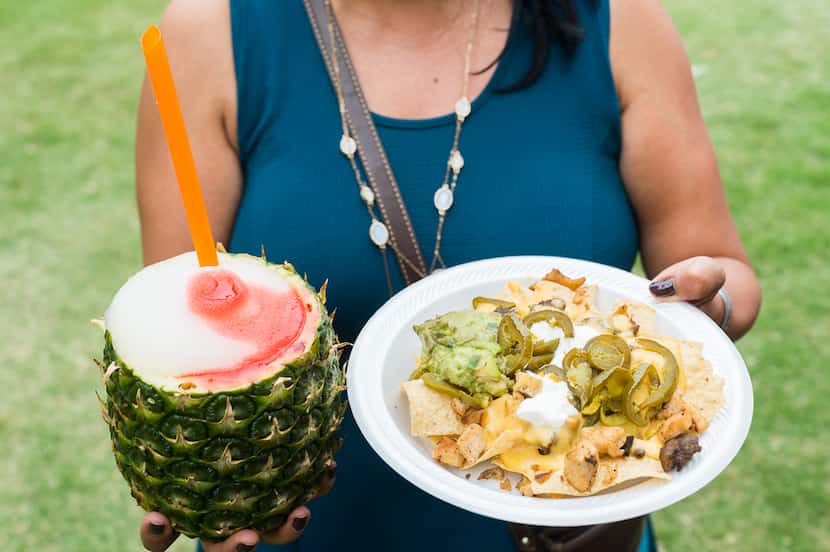 A festivalgoer shows her nachos and pineapple drink at the 2017 Taste Addison.