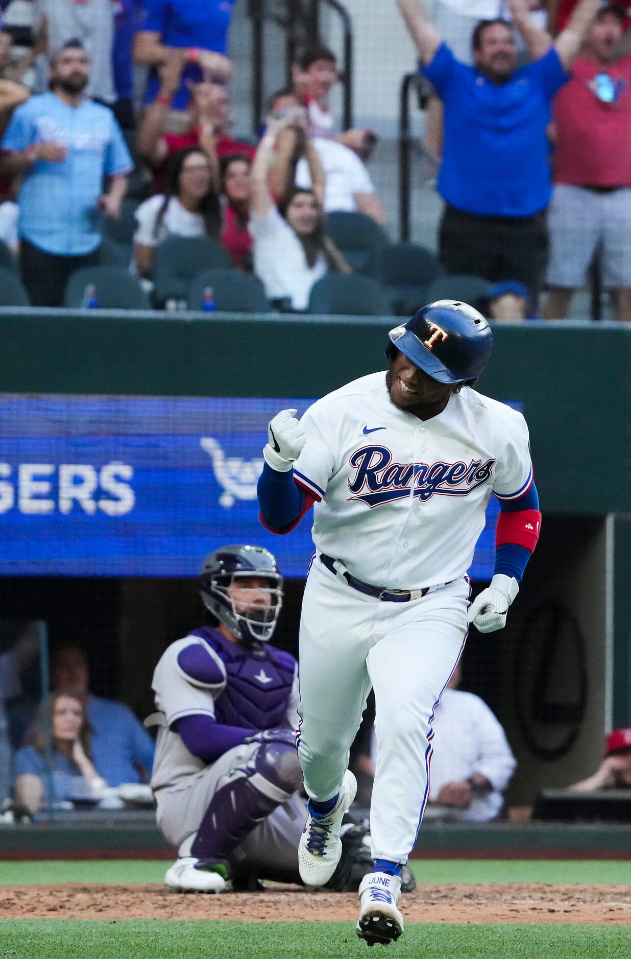 Texas Rangers pinch hitter Willie Calhoun celebrates after hitting a solo home run to tie...