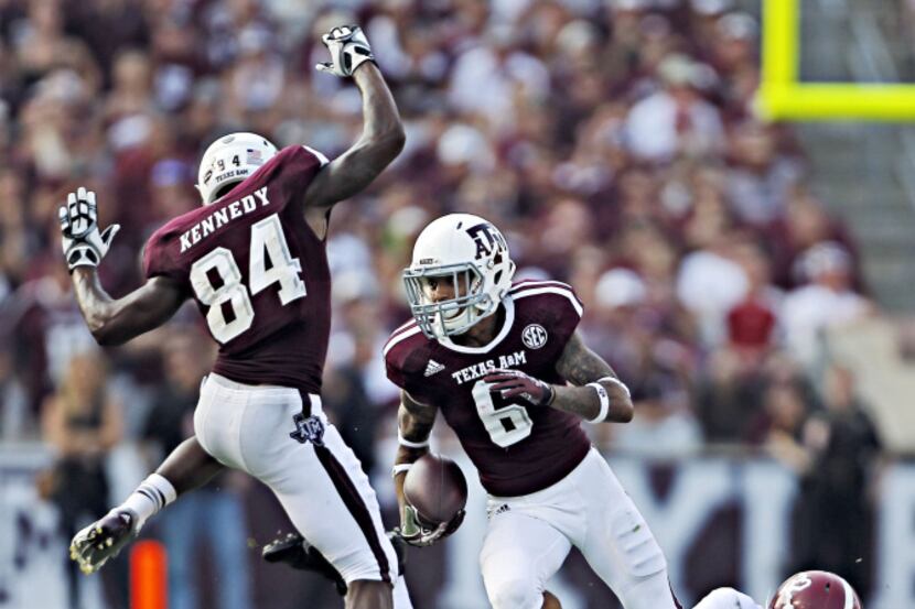 Texas A&M Aggies wide receiver Malcome Kennedy (84) tries to get out of defensive back Noel...