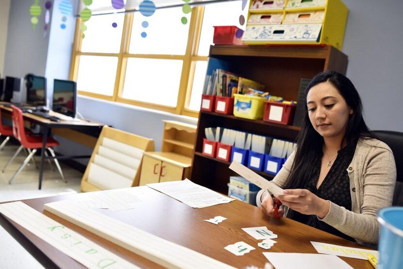 Marisol García-Undiano corta piezas para un rompecabezas que prepara para sus estudiantes en...