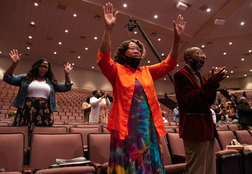 Georgia Williams and her grandson Roland Edmund (right) sing and clap during Bible study at...
