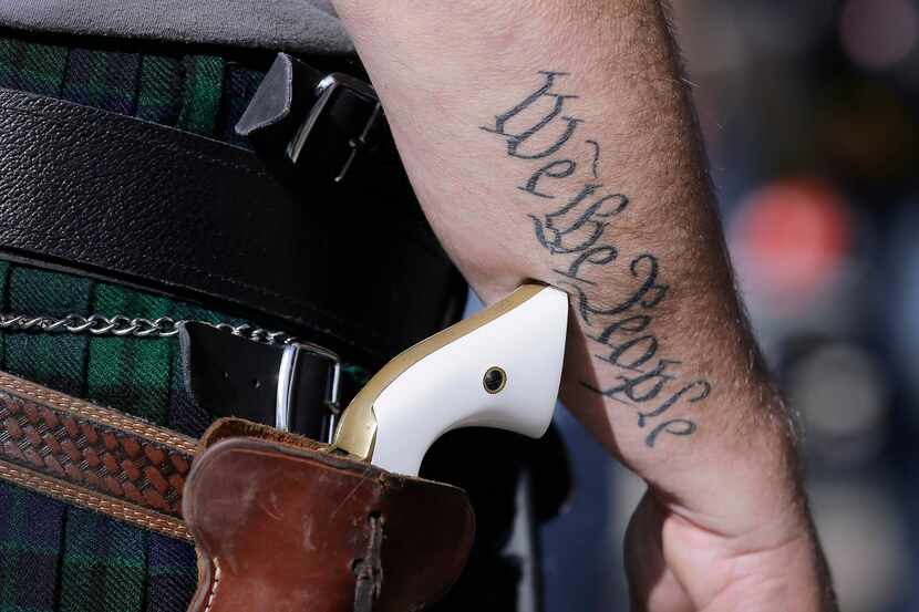 In this 2015 file photo, a supporter of open carry gun laws wears a pistol before a rally in...