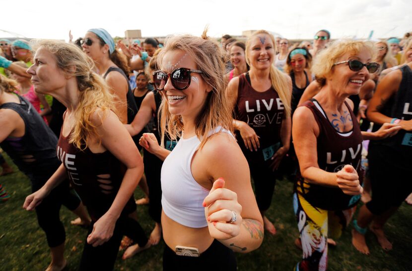 Yoga enthusiasts get excited and fired up by the DJ before their Wanderlust group yoga session.