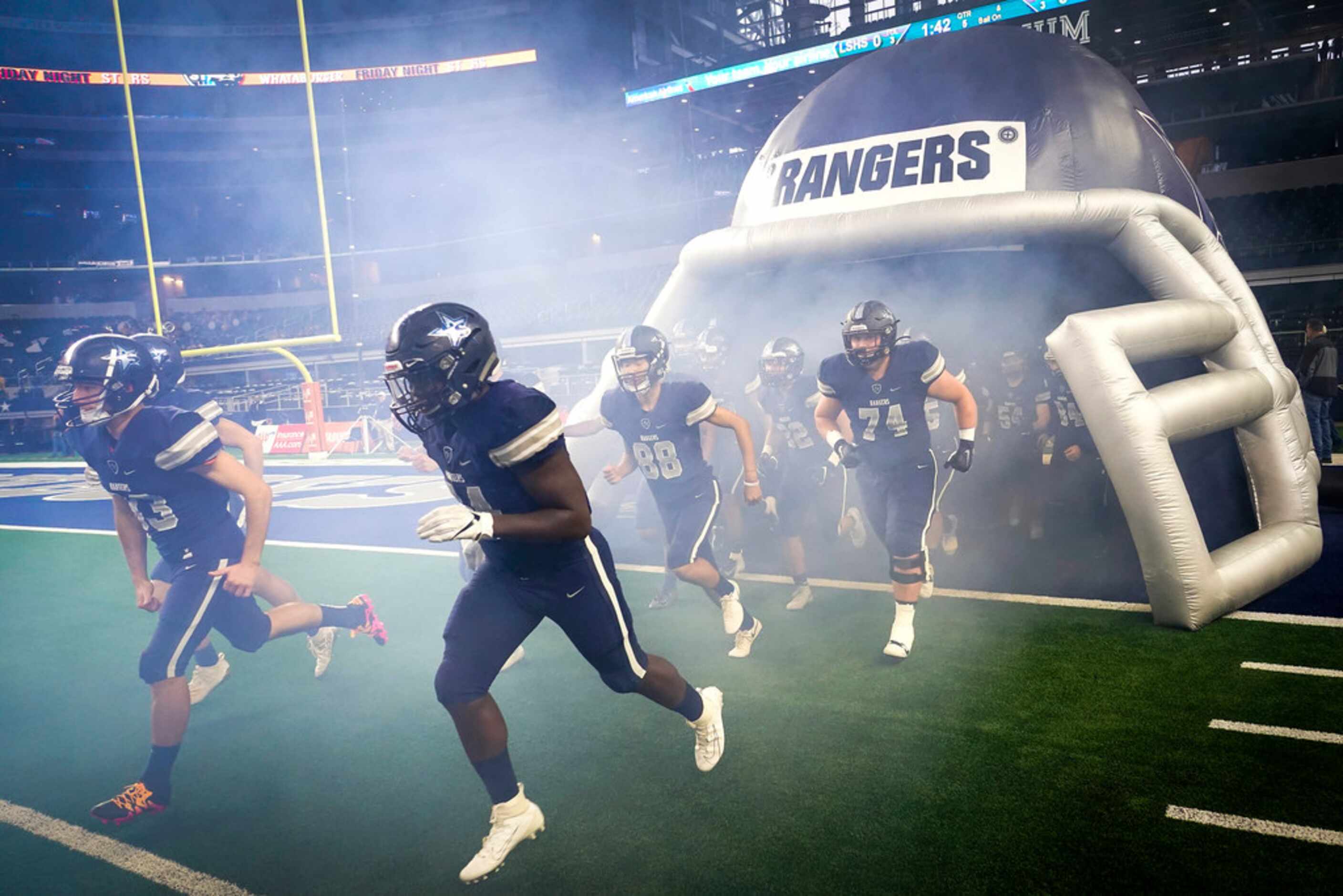 Frisco Lone Star players take the field to face Highland Park in a Class 5A Division I...