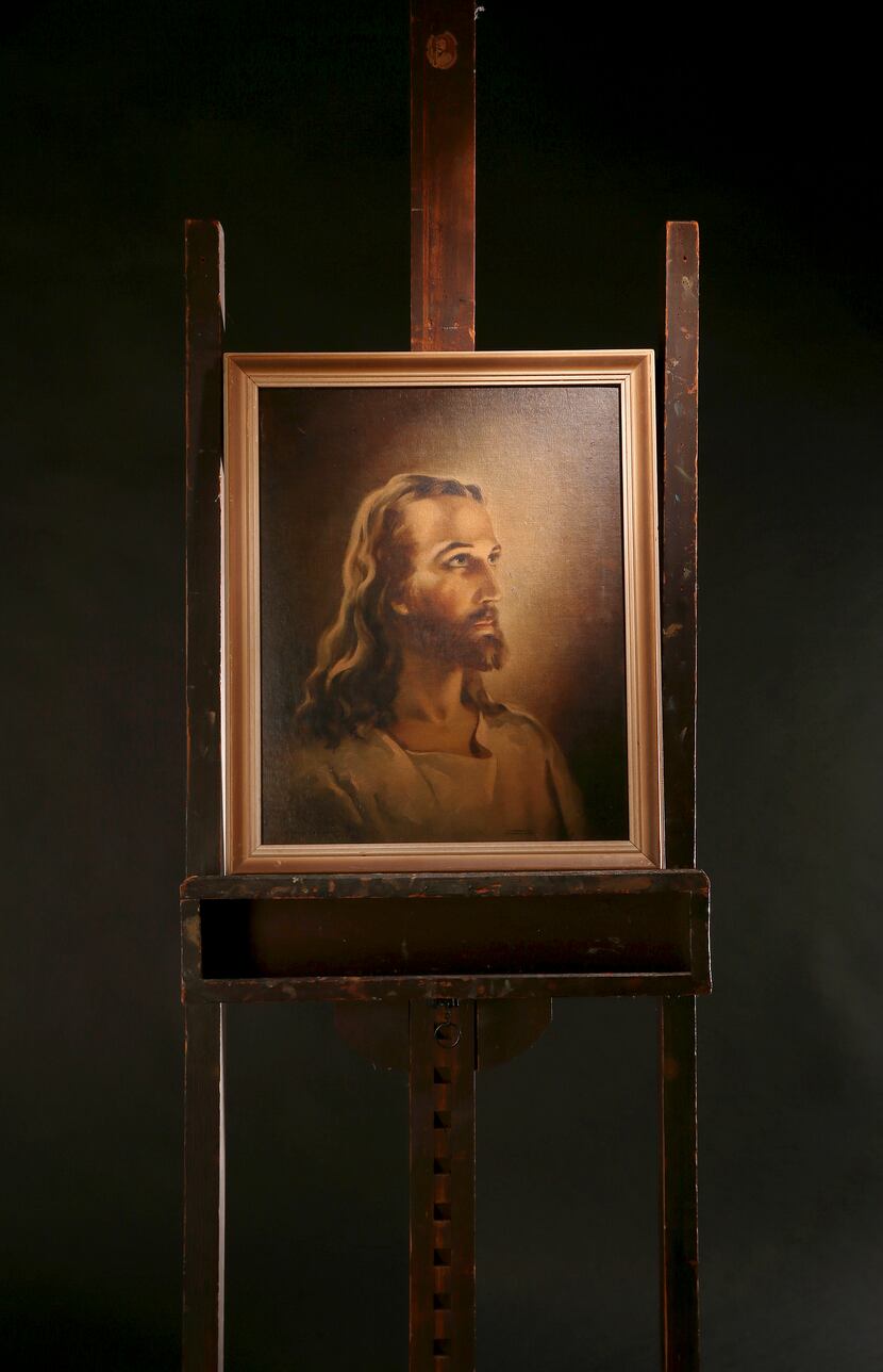 A replica of the Head of Christ by Warner Sallman is shown on Sallman's easel, which his...