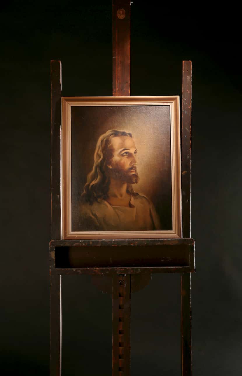 A replica of the Head of Christ by Warner Sallman is shown on Sallman's easel, which his...