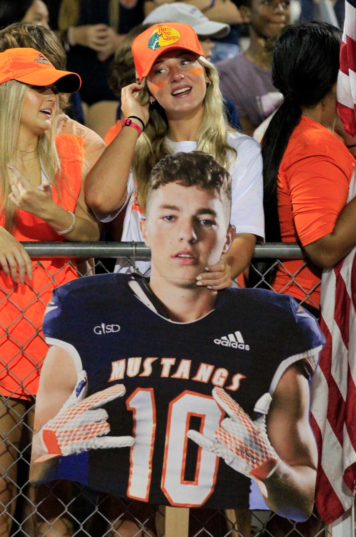 A fan holds up a portrait of Sachse’s Austin Phillips (10) during the first half of a high...