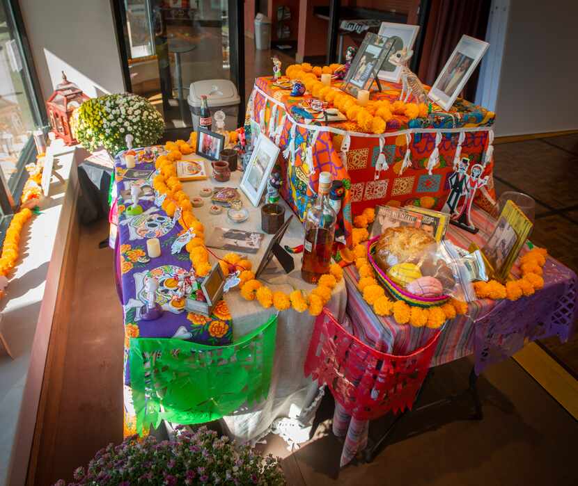 The community Dia de Los Muertos altar is set up in a storefront window at at the Oak Cliff...