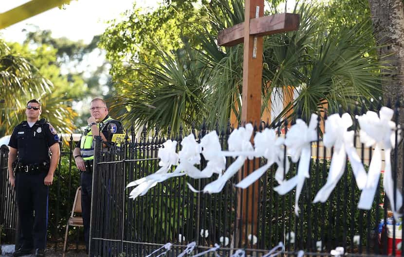 
Charleston, S.C., police officers stood outside the church where a gunman killed nine...