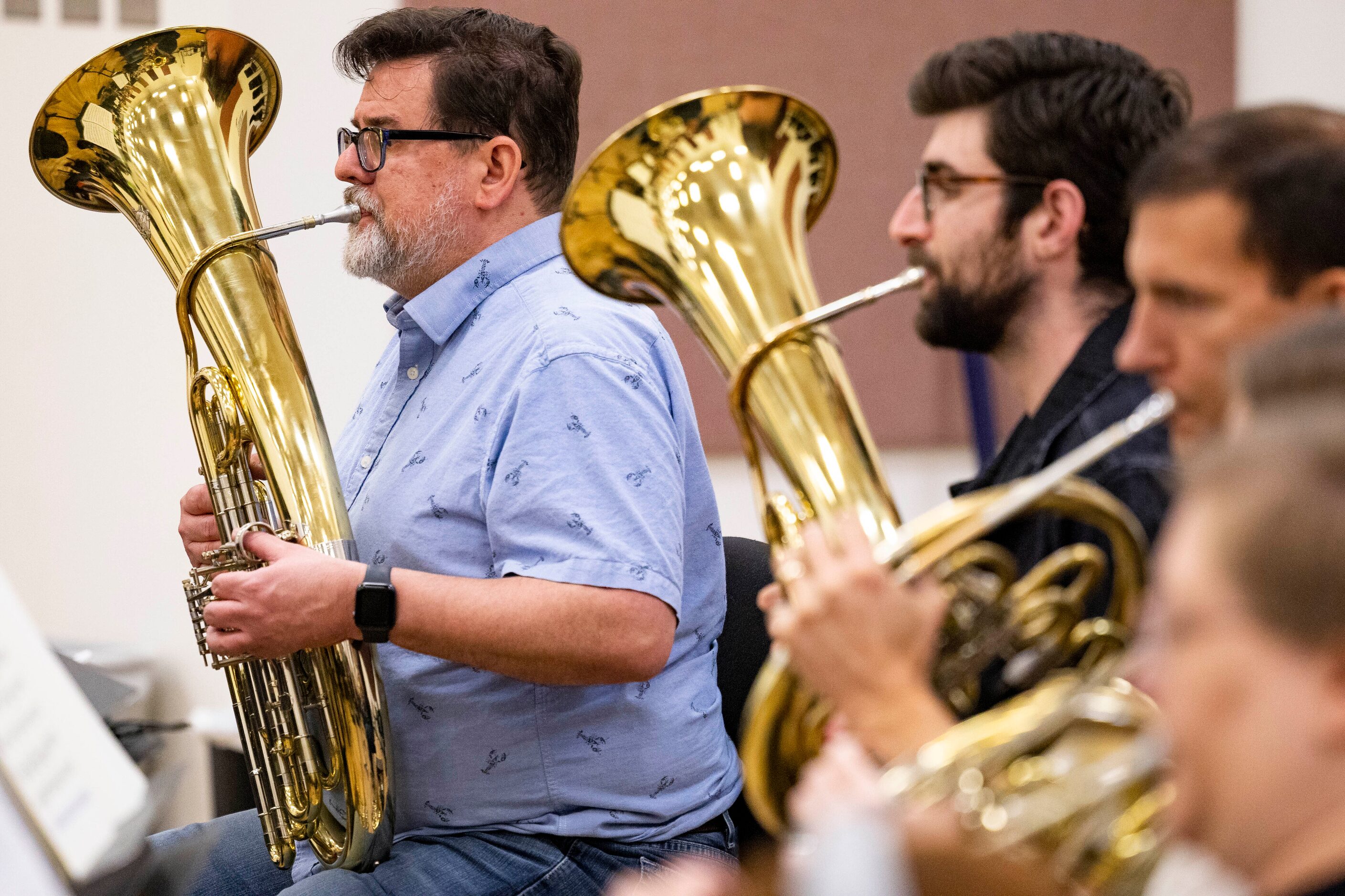 Musicians playing the Wagner tuba perform during the orchestral rehearsal for Dallas Opera’s...