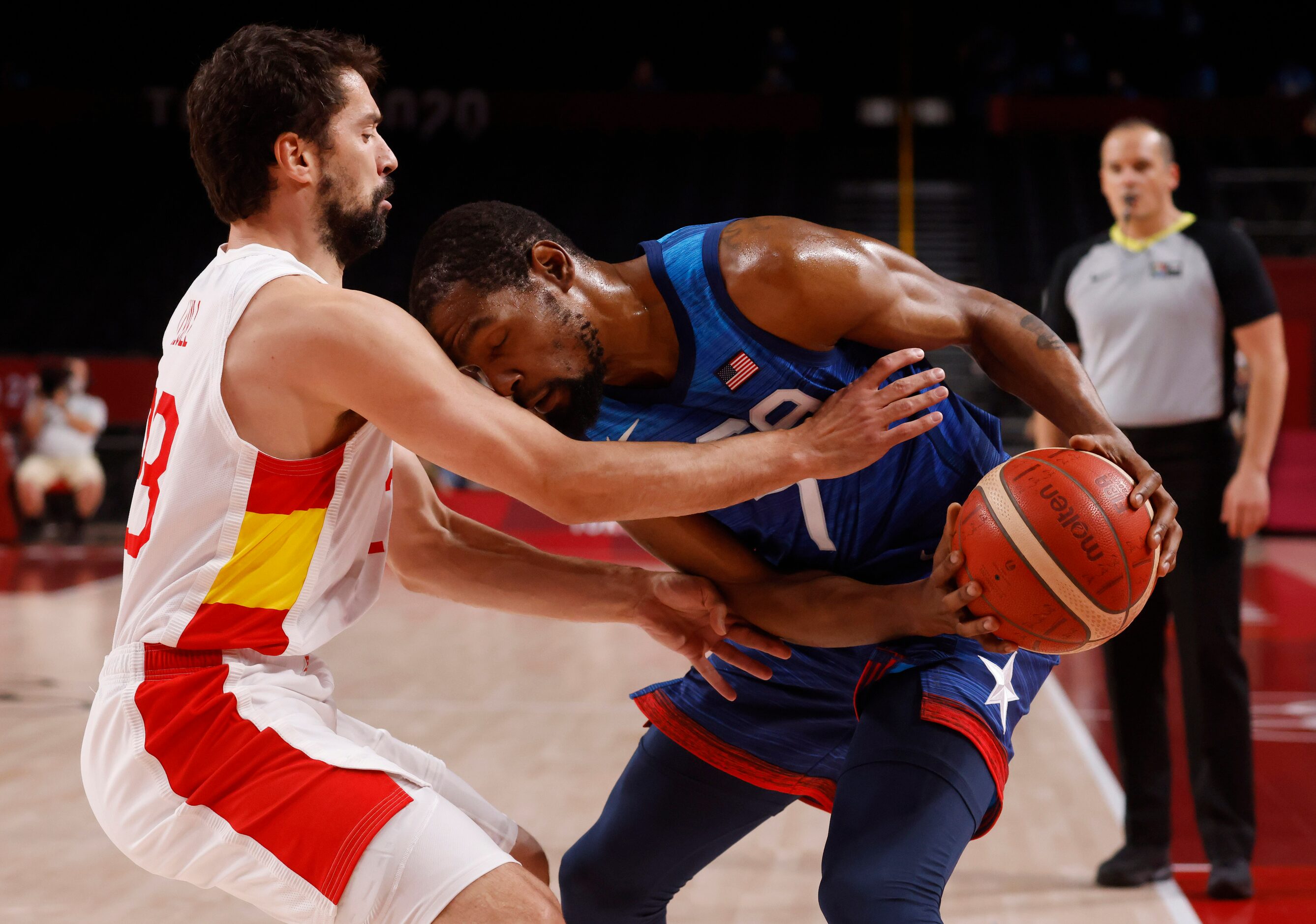 USA’s Kevin Durant (7) attempts to gain space as he is defended by Spain’s Sergio Llull (23)...