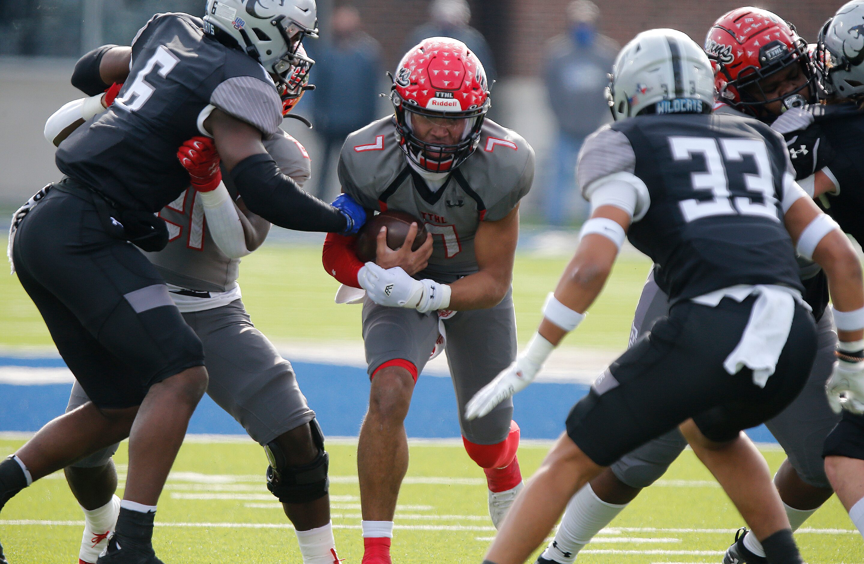 Cedar Hill High School quarterback Kaidon Salter (7) runs between Denton Guyer High School...