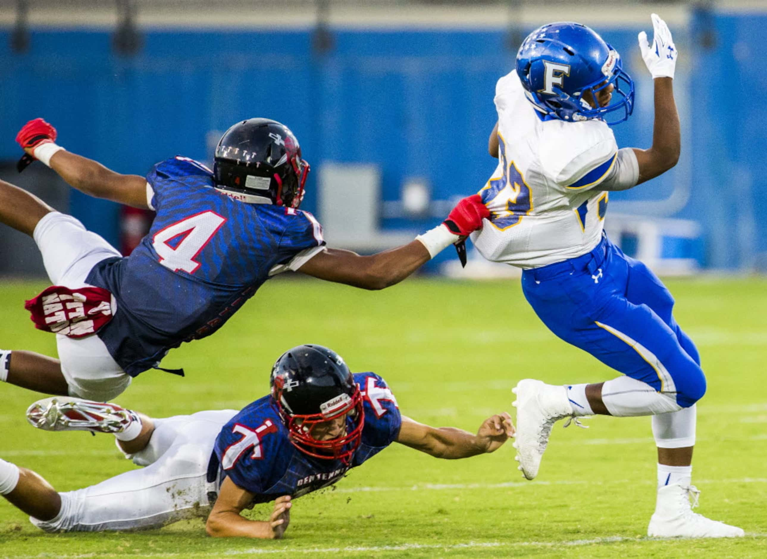 Frisco fullback Idrees Ali (33) is tackled by Frisco Centennial defensive back Jaxon Gibbs...