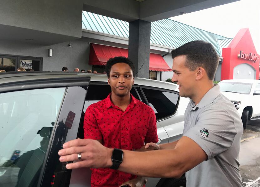 Alabama college student Walter Carr (left) is given keys to a car by Bellhops CEO Luke...
