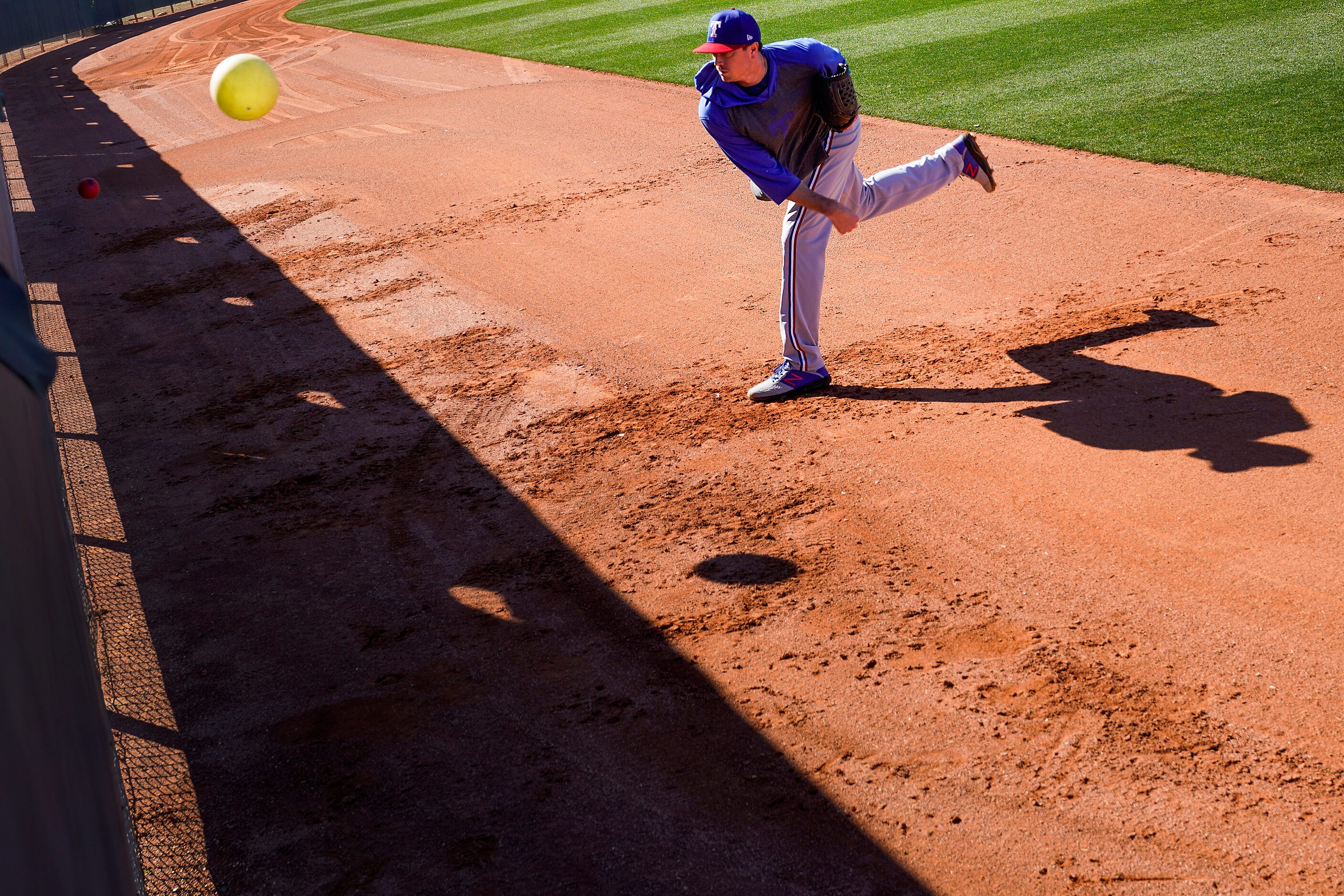 Texas Rangers pitcher Kyle Gibson works with a heavy ball and a connection ball (inflatable...