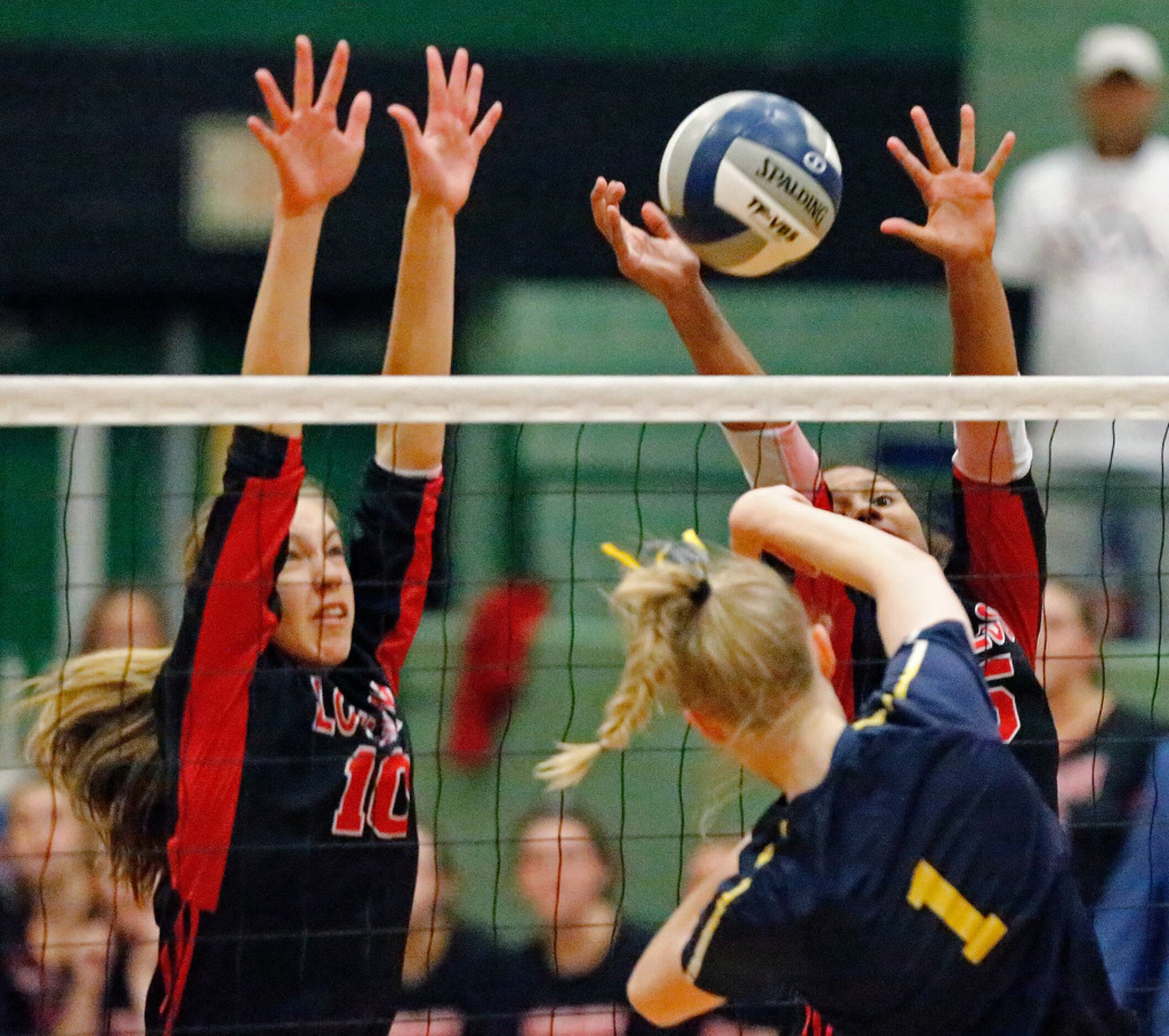 Lovejoy High School middle hitter Grace Milliken (10) and Lovejoy High School outside hitter...