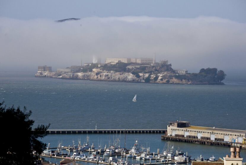 In this photo taken Thursday, Sept. 27, 2012, a sailboat makes its way past Alcatraz Island...
