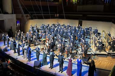 Singers, Dallas Symphony Orchestra and music director Fabio Luisi take bows after...