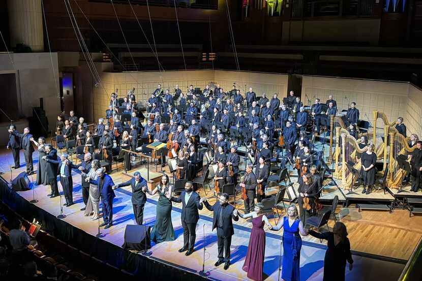 Singers, Dallas Symphony Orchestra and music director Fabio Luisi take bows after...