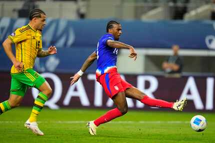 United States' Haji Wright, right, shoots a goal in front of Jamaica's Joel Latibeaudiere...