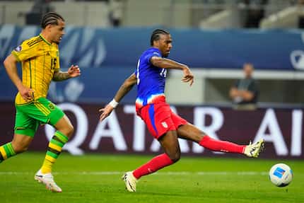 United States' Haji Wright, right, shoots a goal in front of Jamaica's Joel Latibeaudiere...