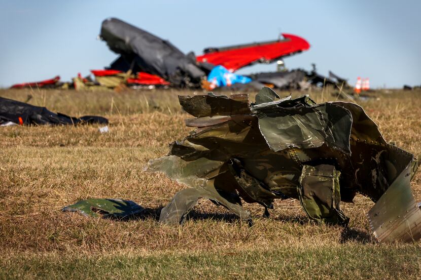 Debris lays across the open field at Dallas Executive Airport on Sunday, Nov. 13, 2022, in...