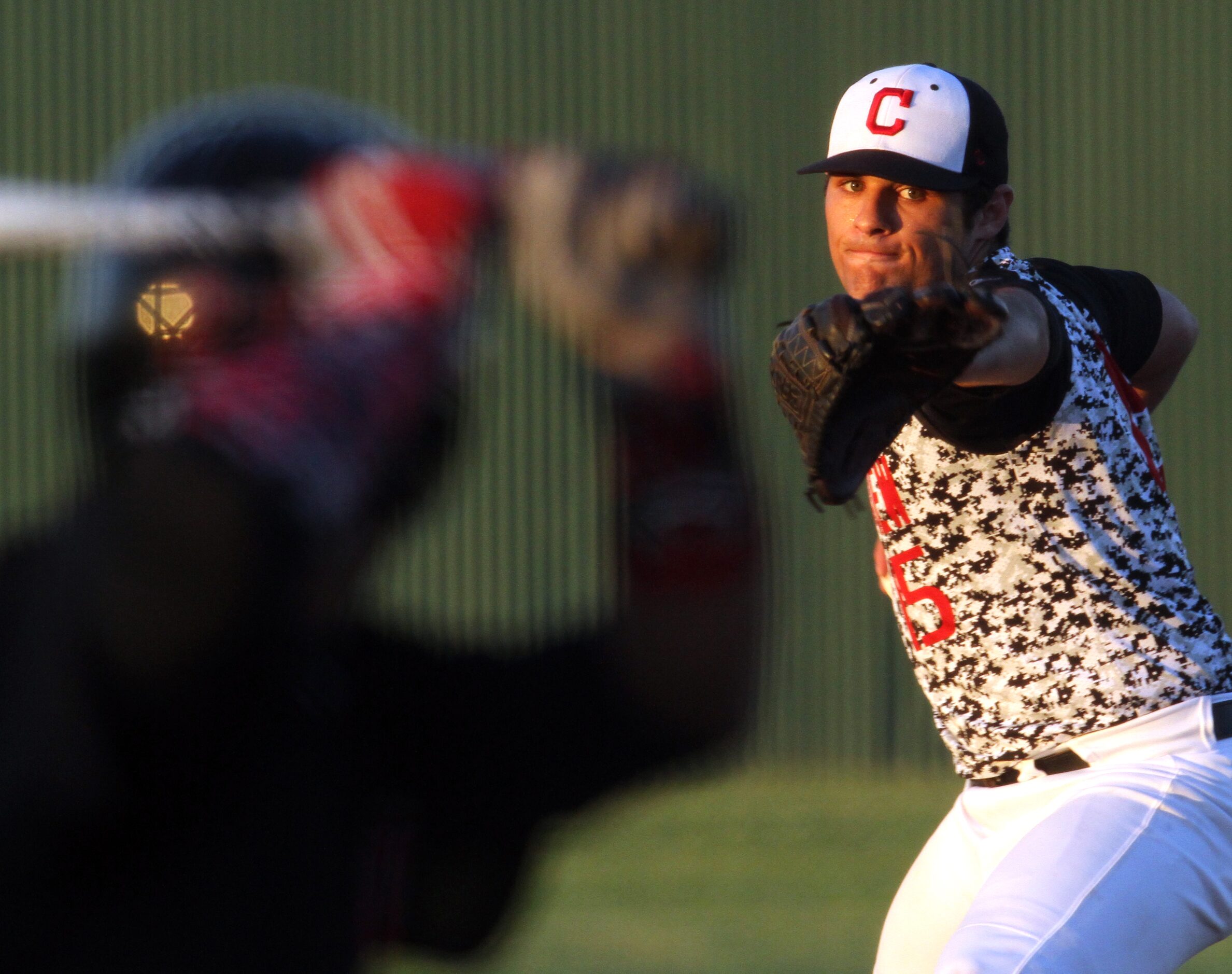 Carrollton Creekview pitcher Brandon White (15) delivers a pitch to a Dallas Hillcrest...