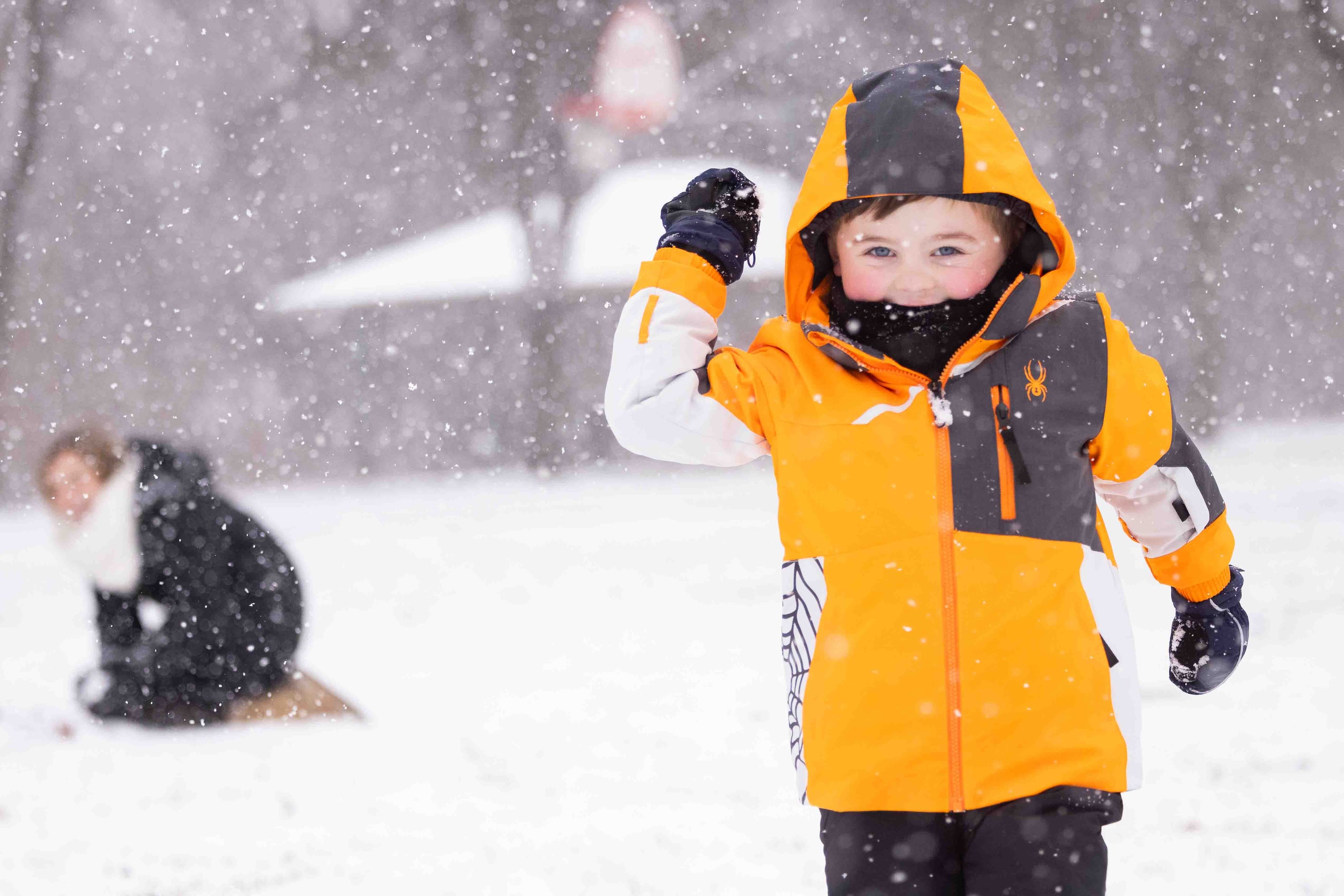 Luke Talman, 4, runs towards the camera with a snowball at Frankford Park in Dallas as snow...