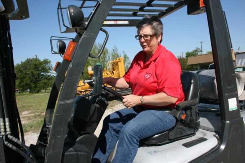 
Susan Frank operates a forklift outside Hearts for Homes’ warehouse in Denton. Frank’s...