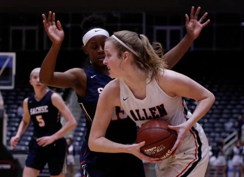 Allen post Grace Woodruff (33) looks to pass as she is defended by Sachse guard Jayla Brooks...