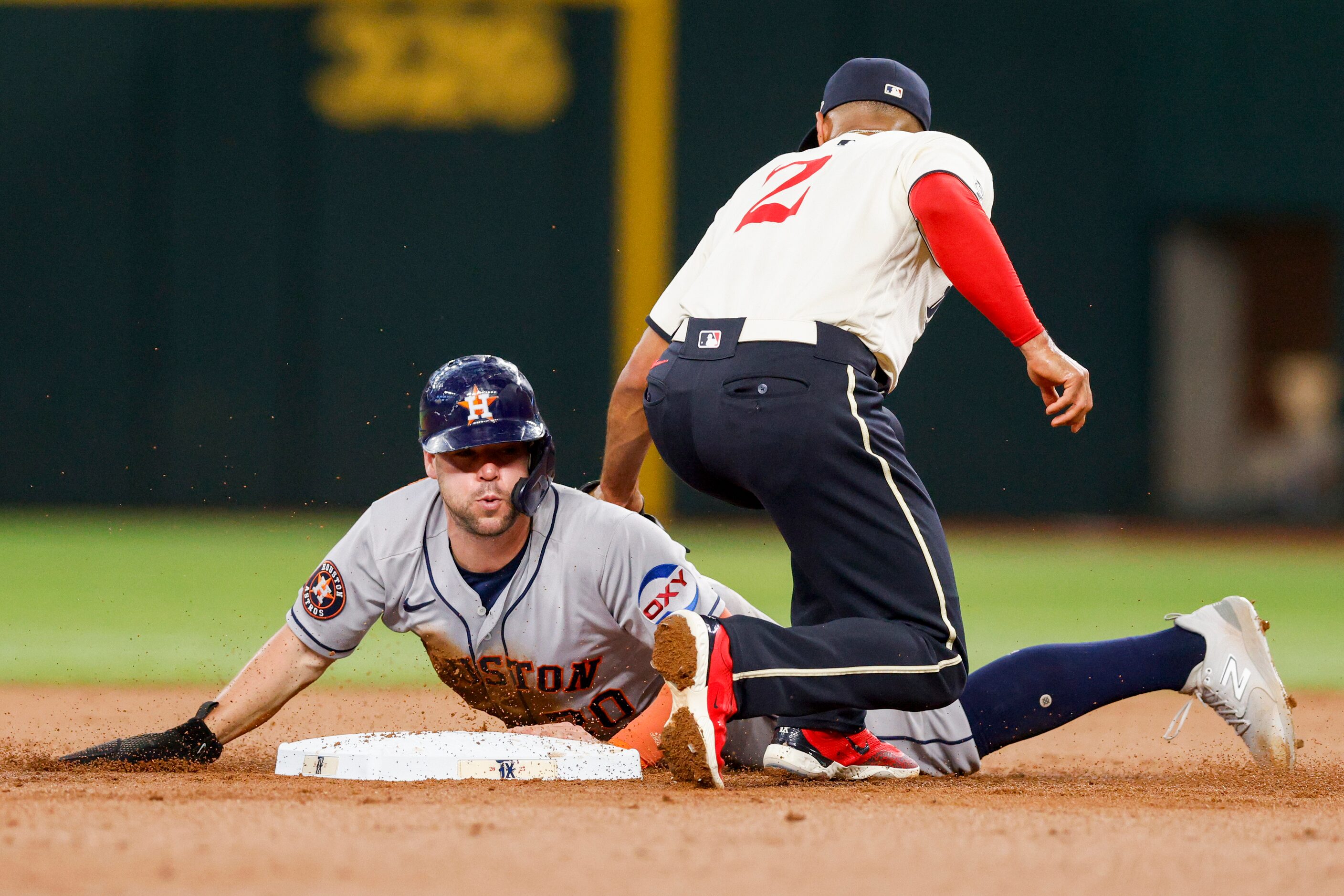 Houston Astros left fielder Chas McCormick (20) steals second base ahead of Texas Rangers...