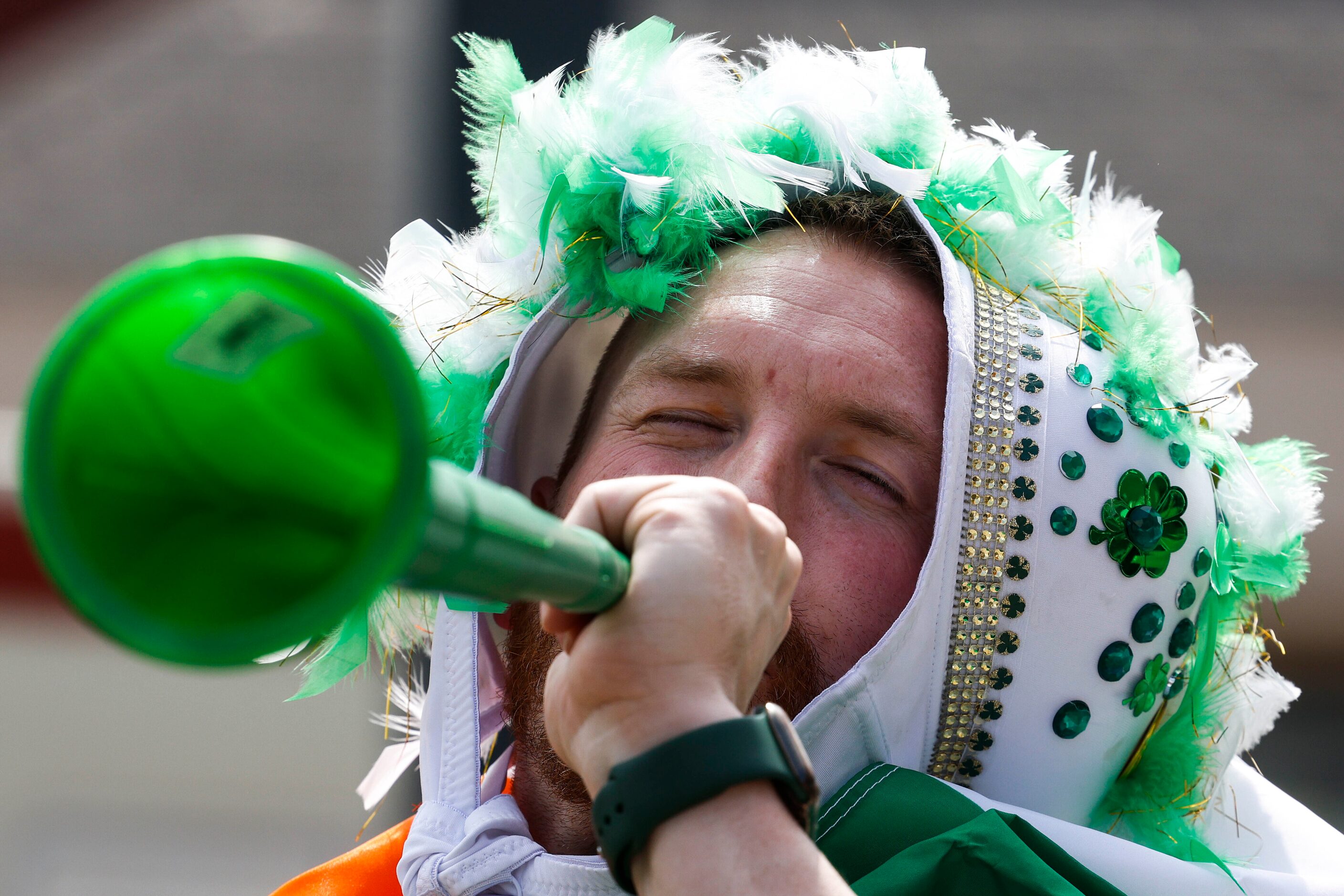 Chase Nation blows a vuvuzela during a Saint Patrick's Day parade on Saturday, March 11,...