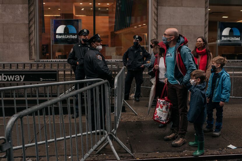 A family is stopped at a New York police barricade shortly before the Macy's Thanksgiving...