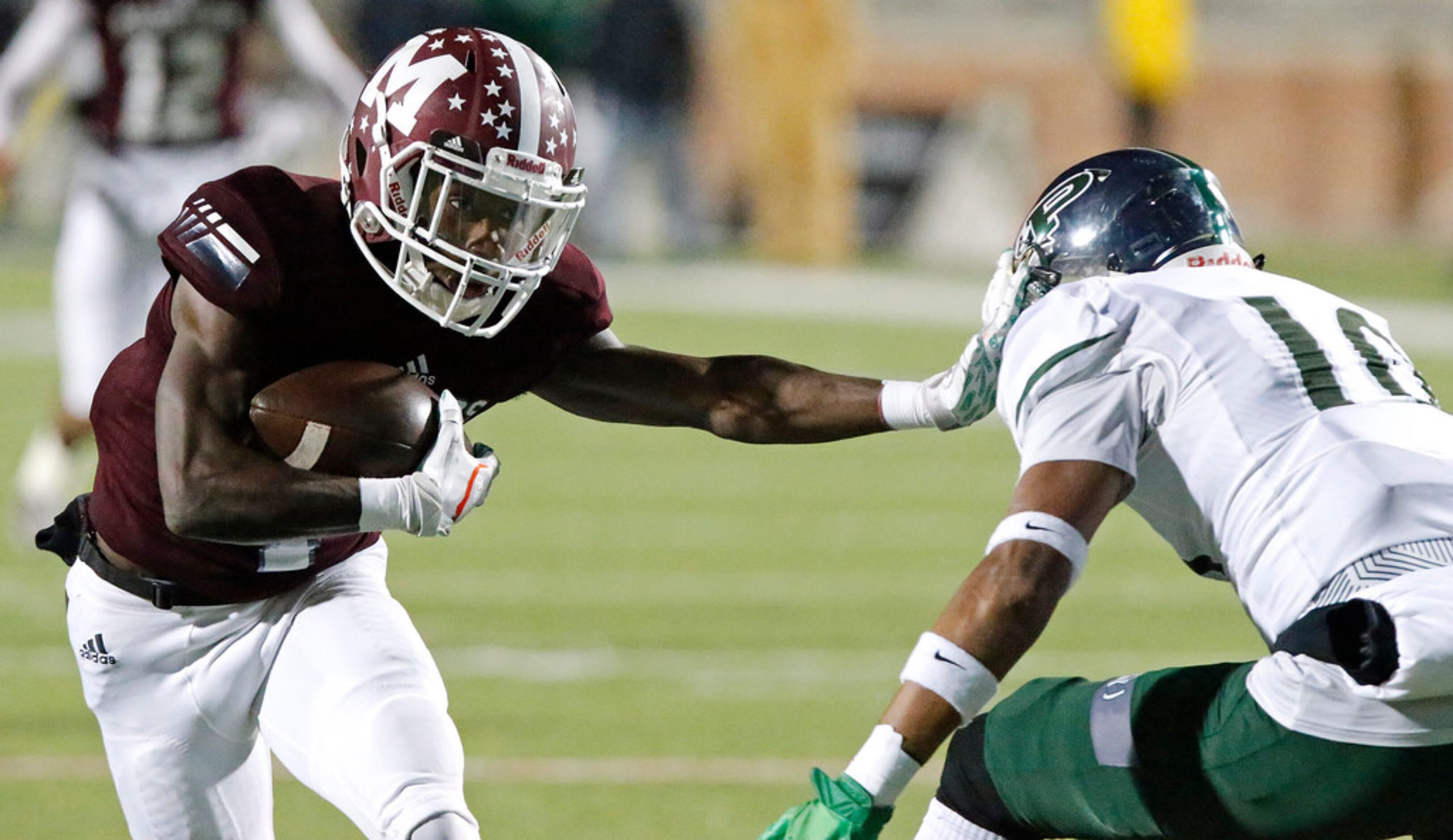 Mesquite High School running back Ladarius Turner (4) stiff arms Prosper High School...