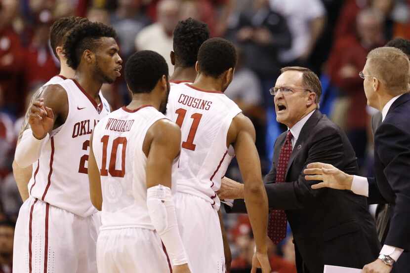 Oklahoma Sooners head coach Lon Kruger talks to his players during a timeout in the second...