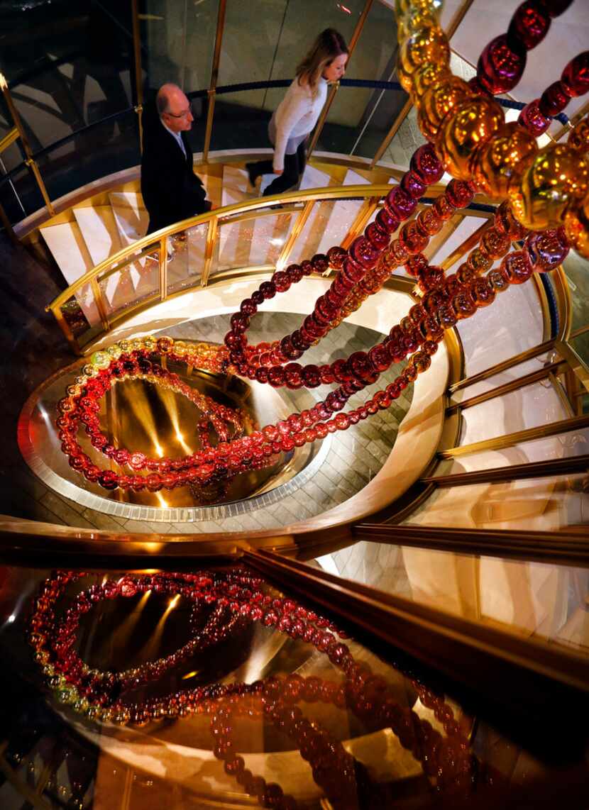 The Necklace of Dreams sculpture by Jean-Michel Othoniel lines the circular staircase at the...