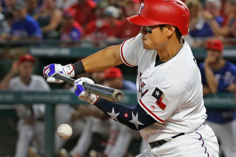 Texas Rangers designated hitter Shin-Soo Choo (17) tries to bunt his way on, but fouls off...