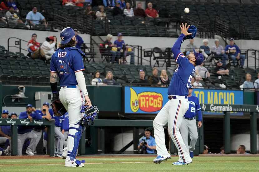 Texas Rangers starting pitcher Martin Perez (54) catches a fly ball in the infield during...
