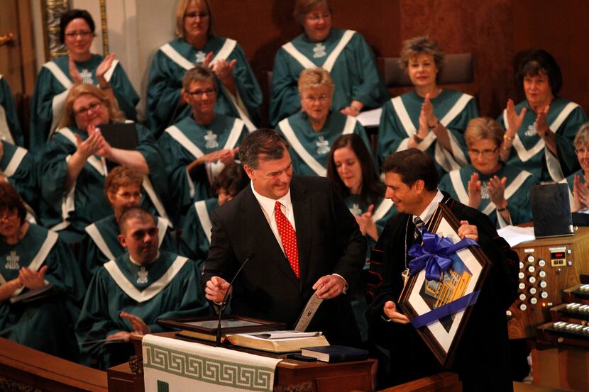 In this file photo, the Rev. Joe Clifford presents Dallas Mayor Mike Rawlings with a framed...
