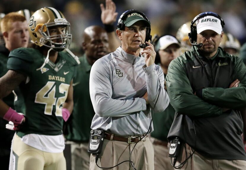 FILE - In this Oct. 19, 2013, file photo, Baylor head coach Art Briles, center, watches...