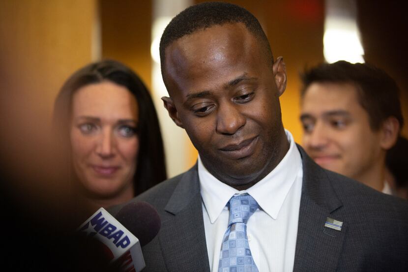 Former Mesquite police officer Derick Wiley holds back tears while addressing reporters...